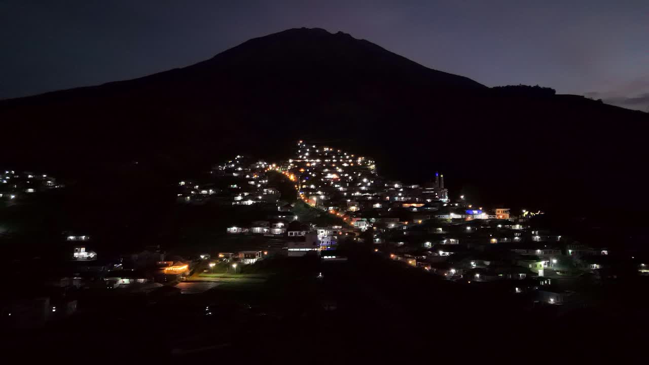 vista aérea de un hermoso pueblo en la ladera de la montaña por la noche