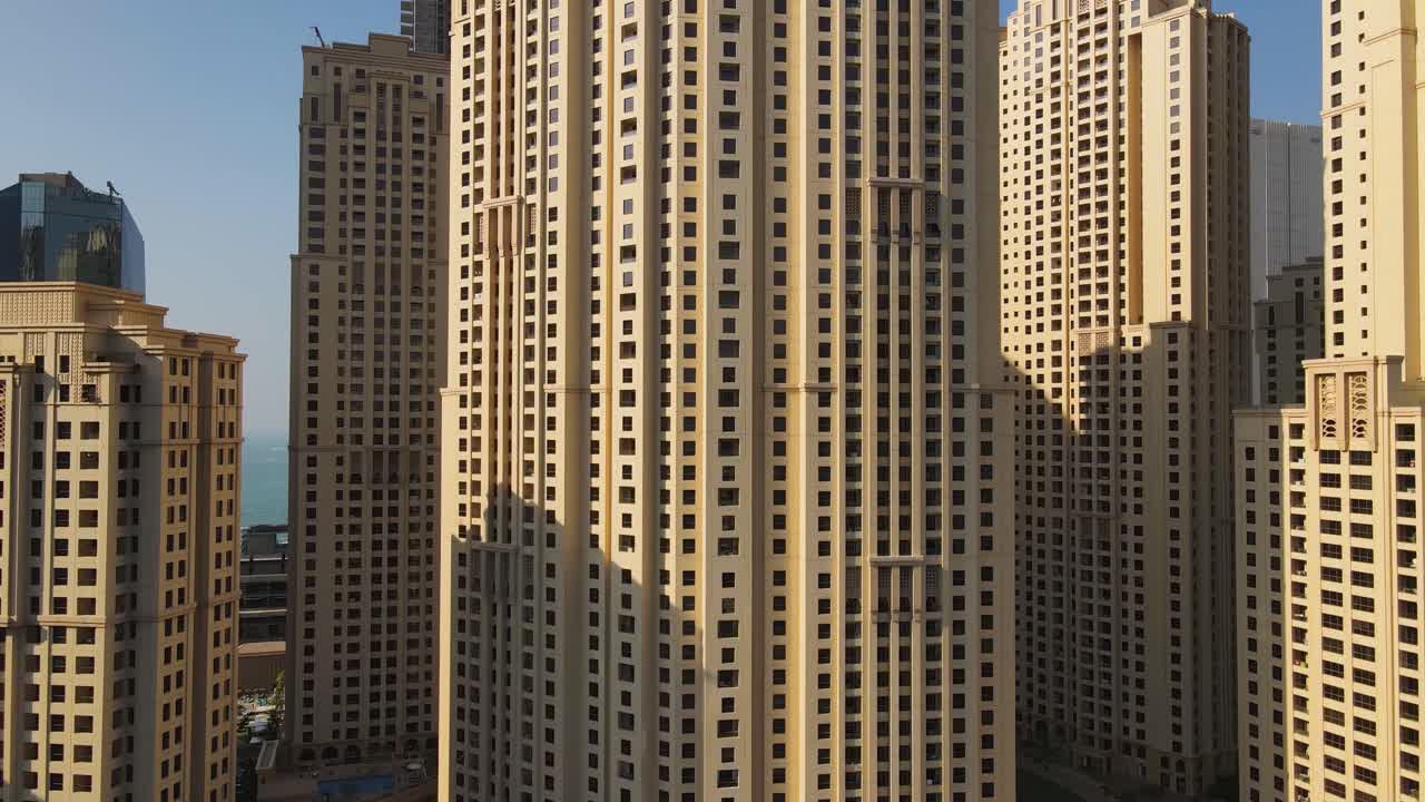 Aerial footage capturing stunning skyscrapers of Jumeirah Beach Residence showcasing impressive architecture and the vibrant urban landscape of one of Dubai's most popular waterfront communities
