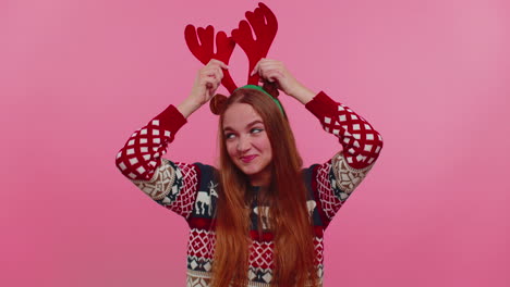 Young-adult-girl-in-Christmas-deer-antlers-listening-music,-dancing-disco-fooling-around-having-fun