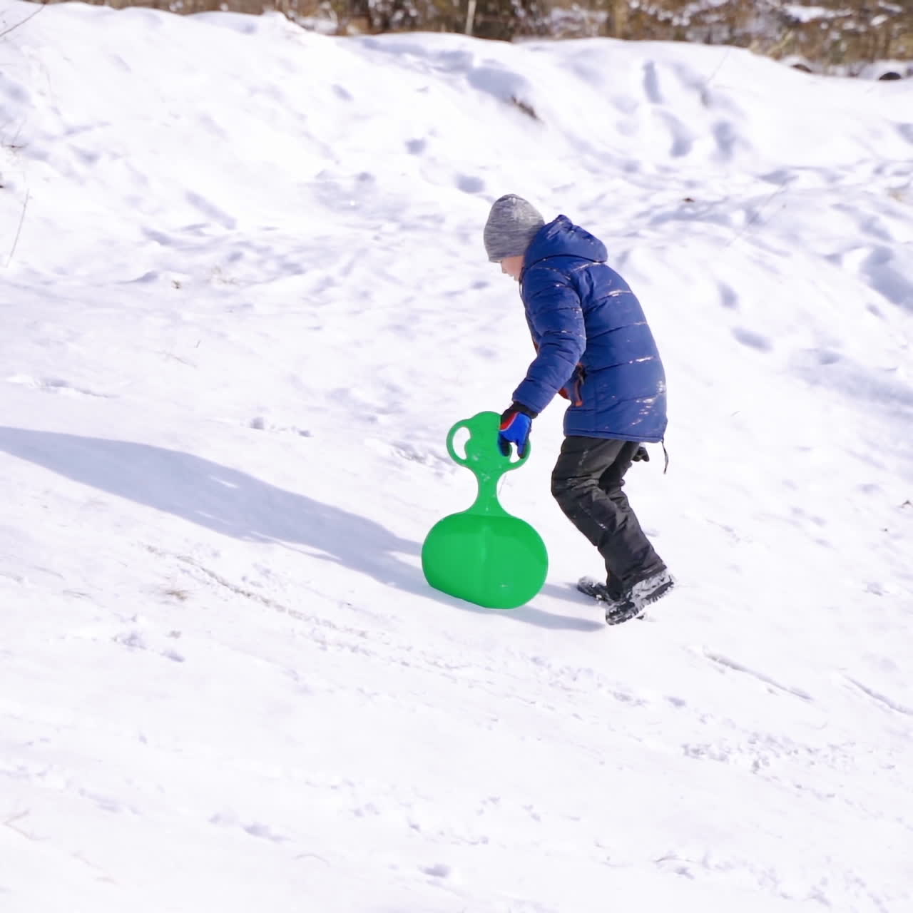 Child boy having fun on snowy winter walk in nature. Frost winter season.Cute little boy with saucer sleds. winter games and fun.