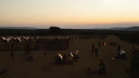 soldiers in a camp at sunset