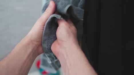 pov of drying hands on a towel after washing, a clear depiction of personal hygiene and self-care in a home bathroom setting