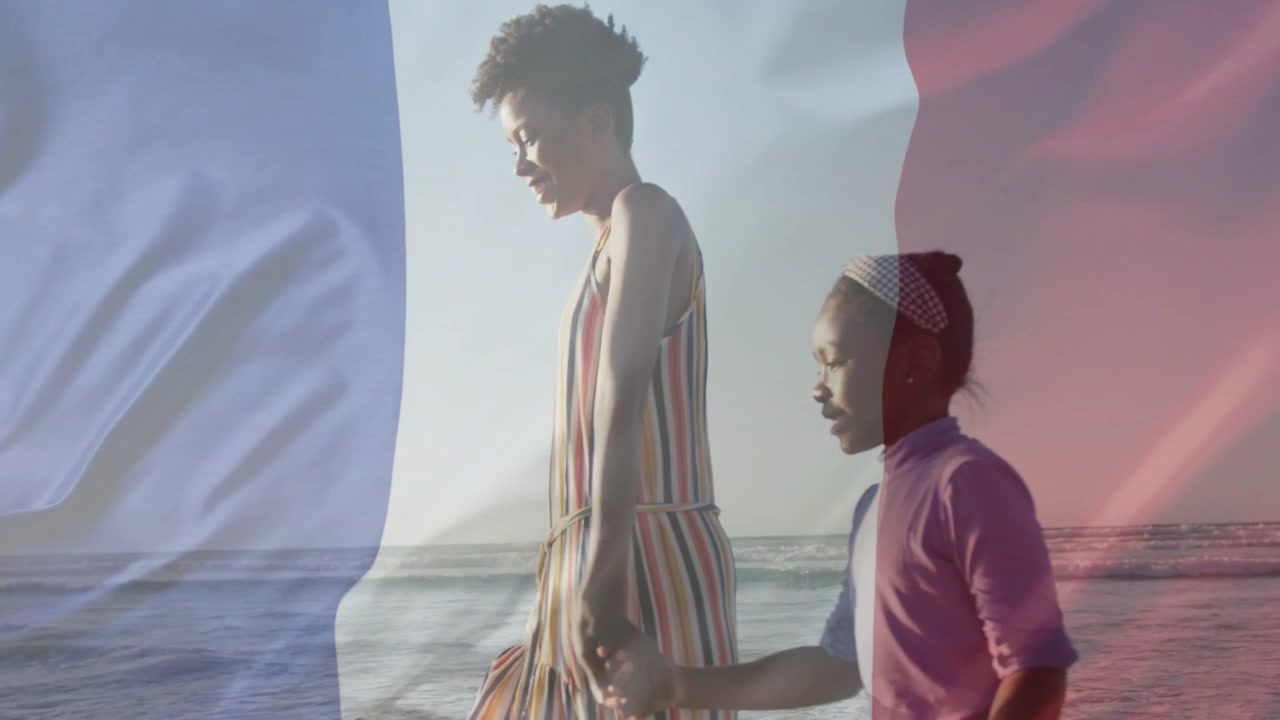 Woman guiding girl walking shoreline for safety while travel flag overlay growing over them
