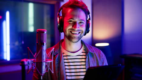 man in recording studio with microphone and headphones