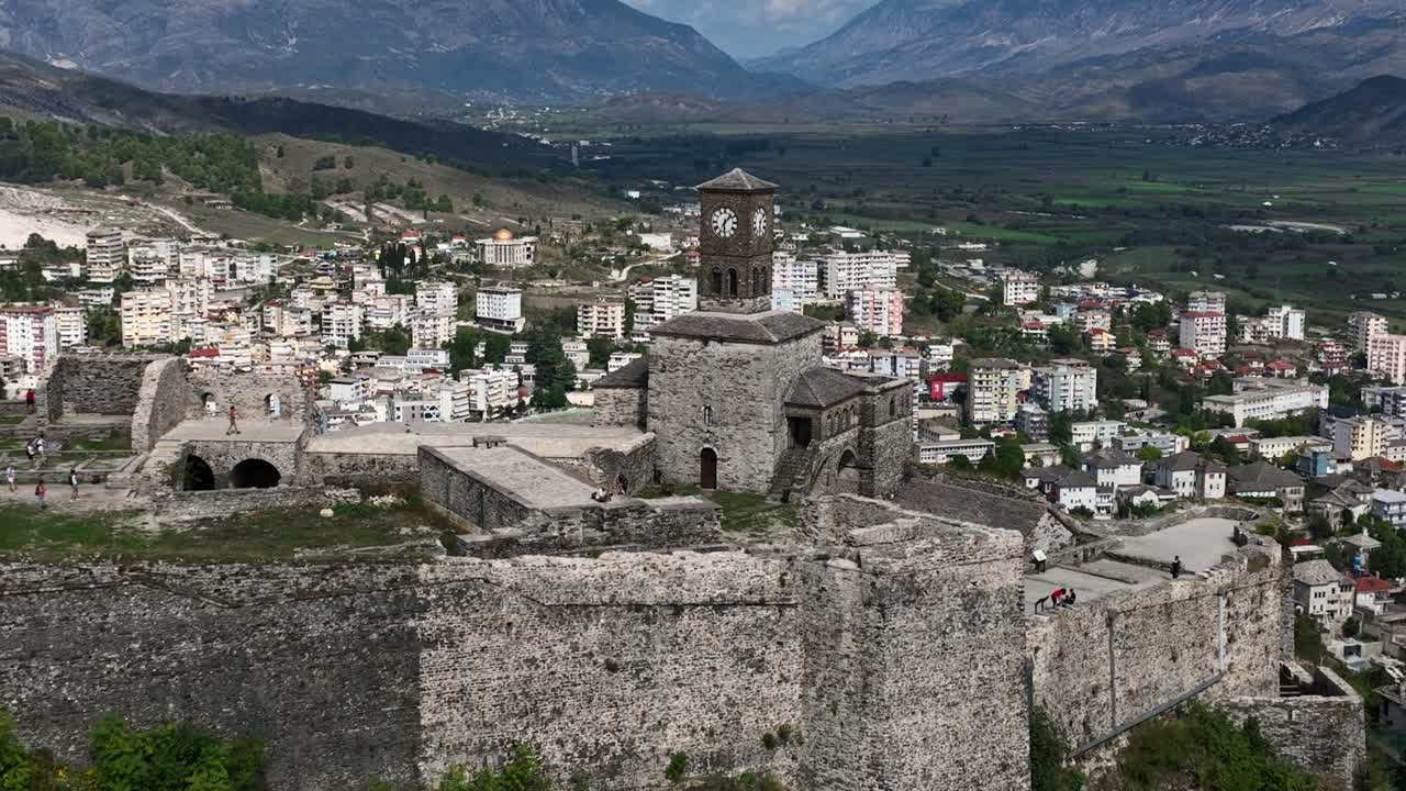 Aerial view of Gjirokastër Castle in Albania with the traditional stone village in the distance.