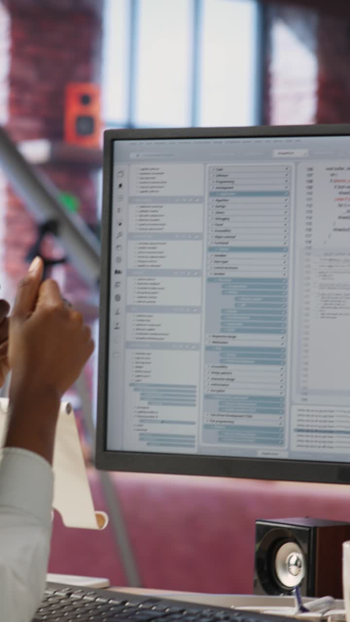 Vertical video IT worker wearing headphones happy after finishing compiling code