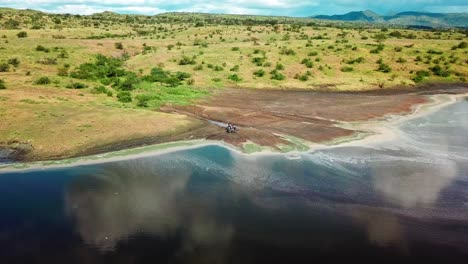 motorcyclists parked beside the beautiful and shallow lake magadi in kenya, africa