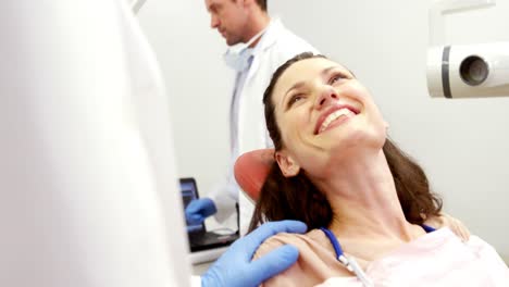 smiling dentist and patient interacting with each other