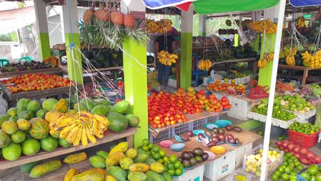 Colourful,-healthy-tropical-fruit-and-vegetables-including-mangoes,-papaya,-avocado,-bananas-and-more-produce-at-local-food-market-in-capital-Dili,-Timor-Leste,-Southeast-Asia