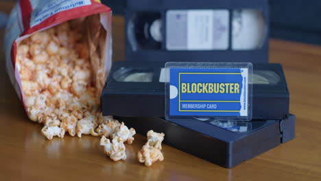 wide pan right shot of a blockbuster membership card with vhs tapes