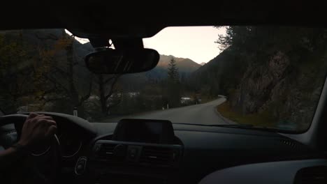 pov point of view car drive in alps valley mountain peaks in austria tyrol with romantic and scenic road in natural landscape