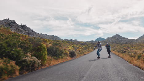 young woman longboarding overtaking in competitive race cruising on countryside road friends skating together riding skateboard slow motion