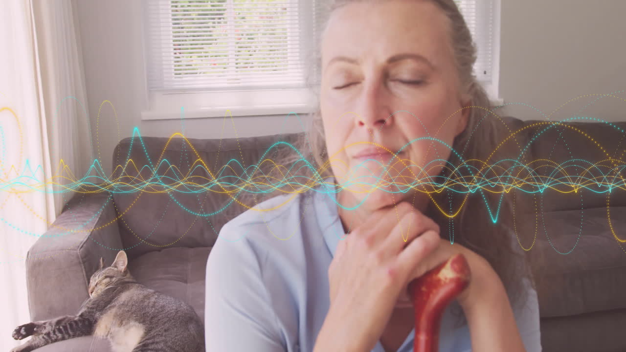 Woman holding cane handle in cozy living room, highlighting healthcare motion waveform overlay