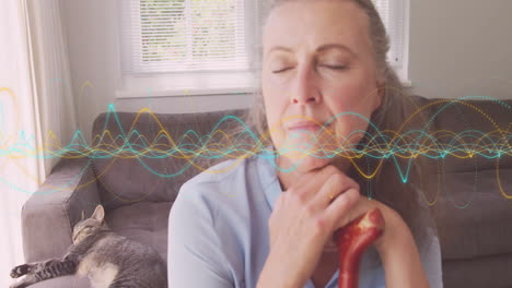 woman holding cane handle in cozy living room, highlighting healthcare motion waveform overlay