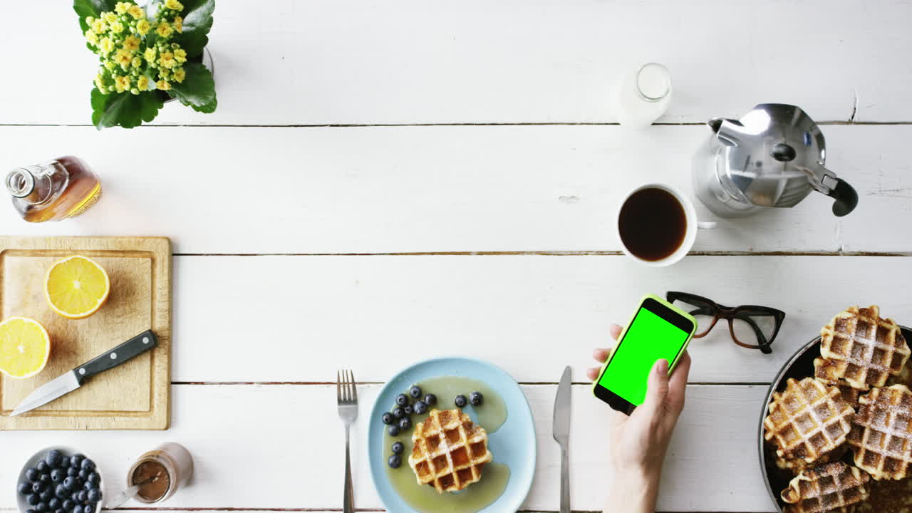 Top view man eating breakfast Belgian waffles and coffee hands from above - Red Epic Dragon