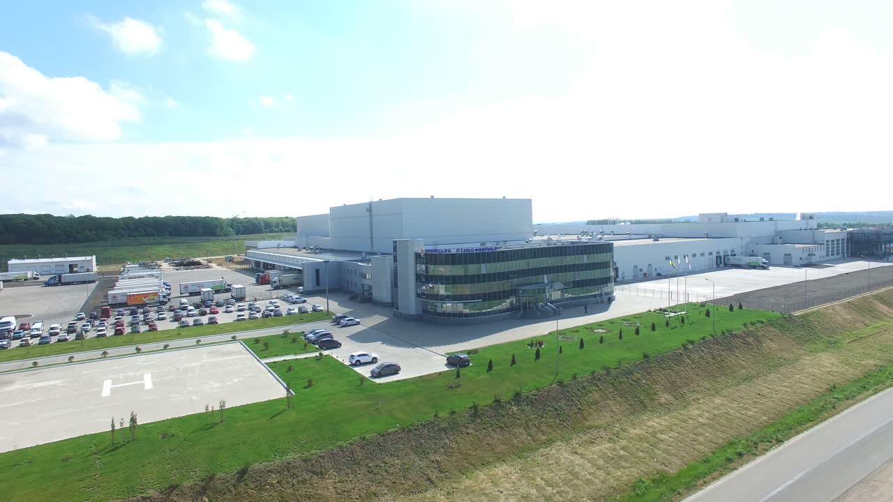 Industrial Area With Factory. Aerial view of a factory or industrial area surrounded by green fields