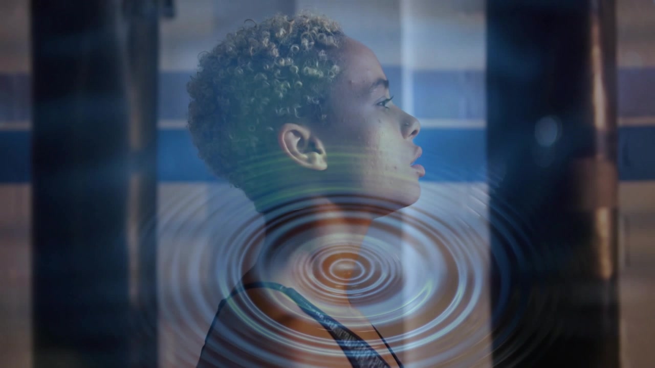 Woman standing in tiled pool, practicing wellness breathing and initiating chest ripples expanding