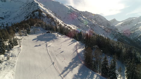 Picturesque-high-view-over-alpine-ski-trail-in-wintertime