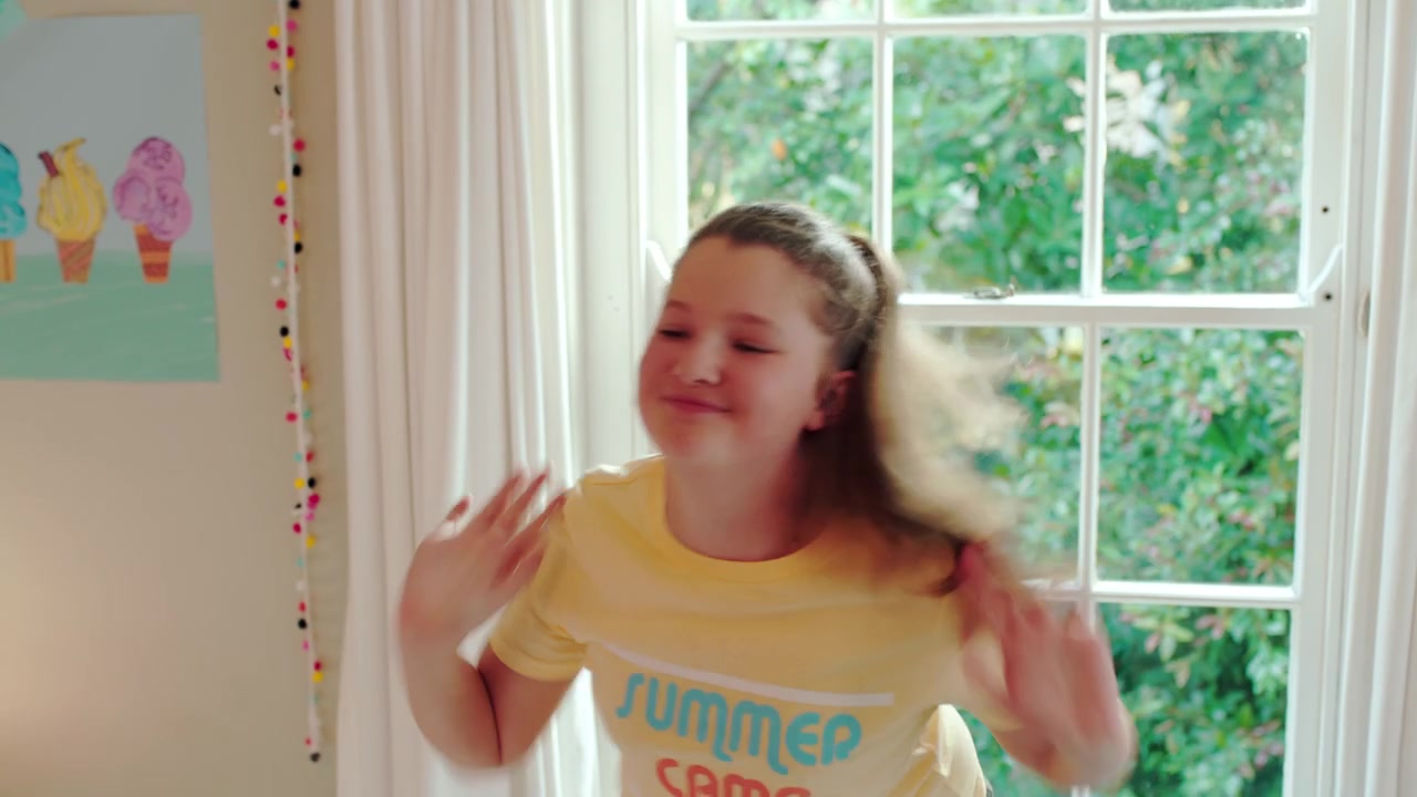 Young Girl Dancing Energetically in Her Bedroom