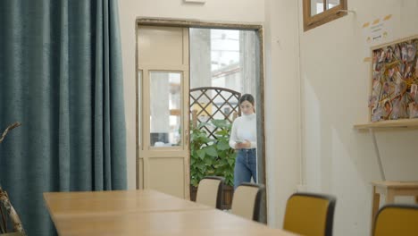 Woman using smartphone in modern co-working space