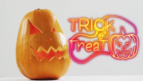 neon trick or treat text banner with pumpkin icon over halloween pumpkins against grey background