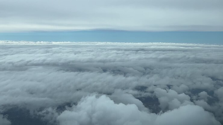 Immersive pilot POV flying between layers of clouds, shot from a jet cockpit