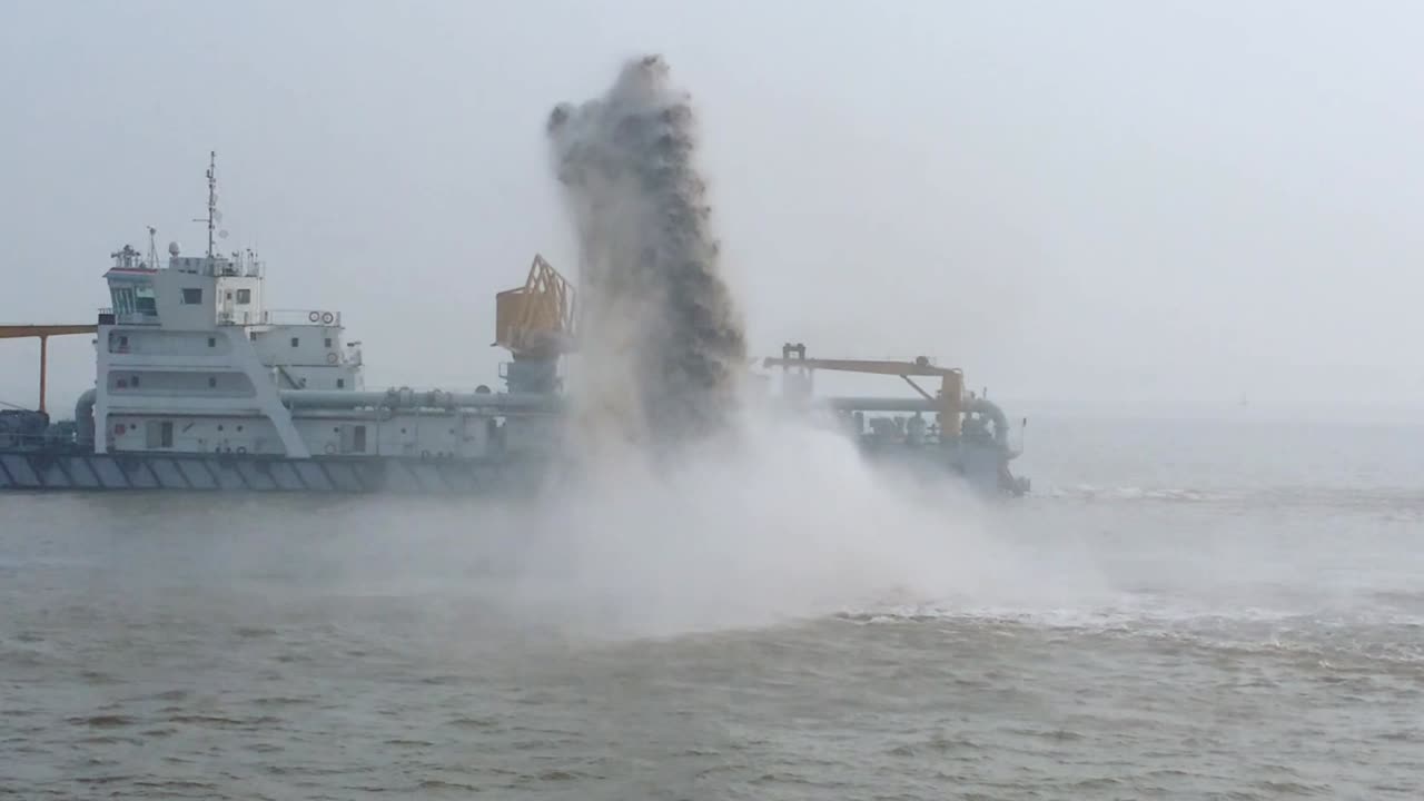 Dredging Vessel in action to keep waterways navigable, excavate and gathering sediments in the bottom and disposing at another location, Shanghai river, China, pan video b roll clip