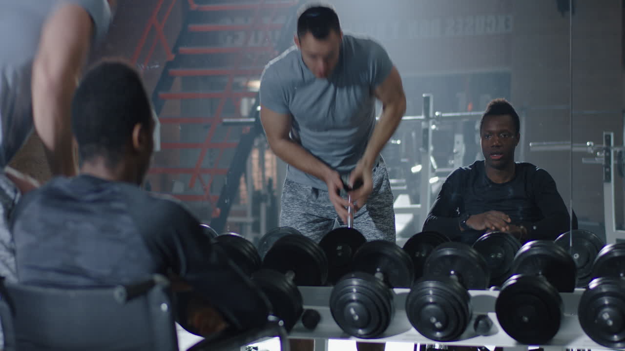 Man in Wheelchair Lifting Weights at Gym Confident Man in Wheelchair Performs Shoulder Press Exercise with Dumbbells at Modern Gym Demonstrating Strength Fitness and Determination