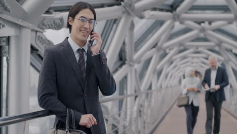 businessman on phone call in modern city bridge