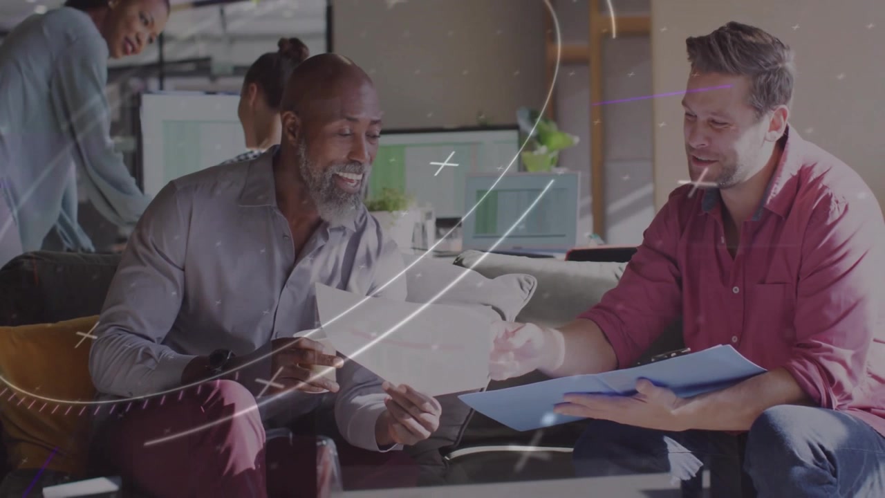 Man pointing folder and colleague leaning to review papers in business lounge with swirling overlay