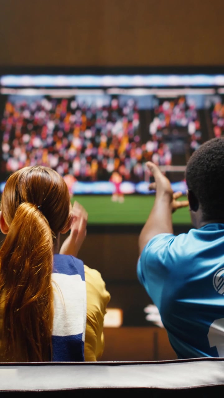 Vertical video Upset football fans at home annoyed after watching missed chance