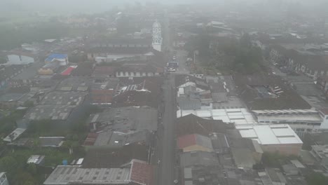 Aerial-view-of-misty-Parque-Bolivar-and-the-church-Parroquia-Inmaculada-Concepción-de-Filandia-in-the-Andean-town-of-Filandia-in-the-Quindío-department-of-Colombia