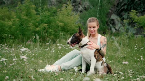 woman and her bull terrier in a park