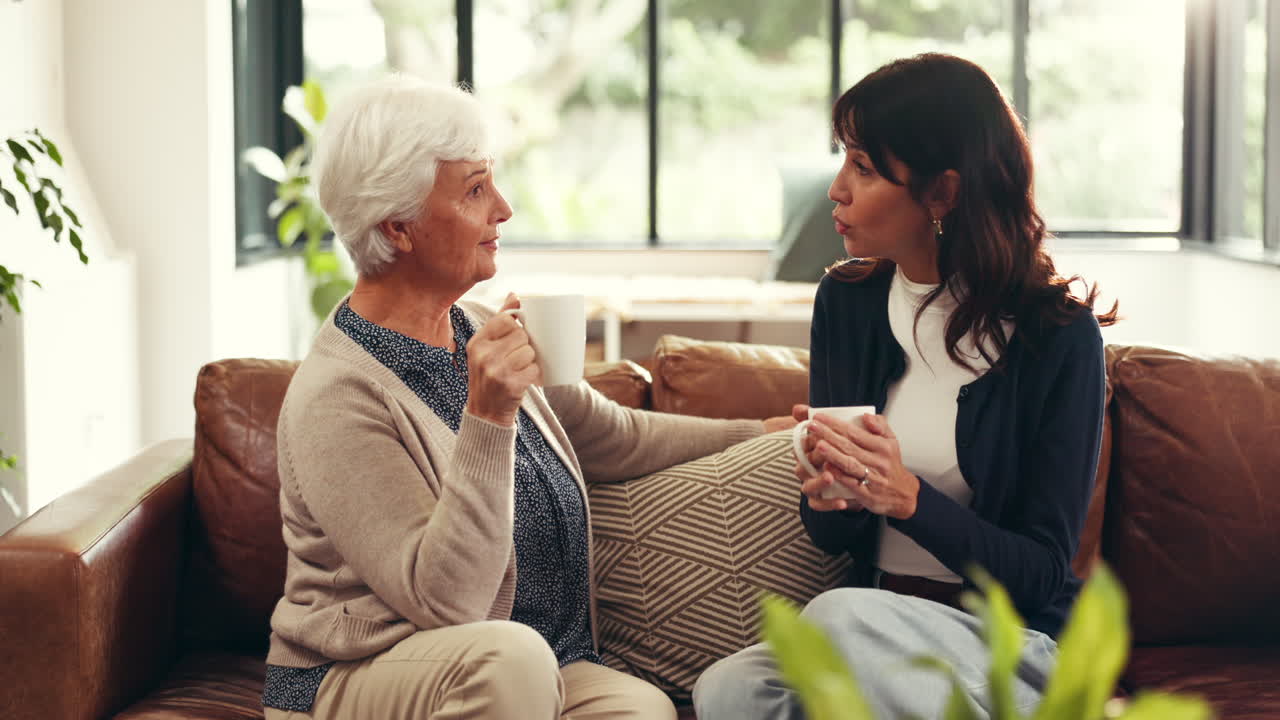 Grandmother and Granddaughter Having Tea and Conversation