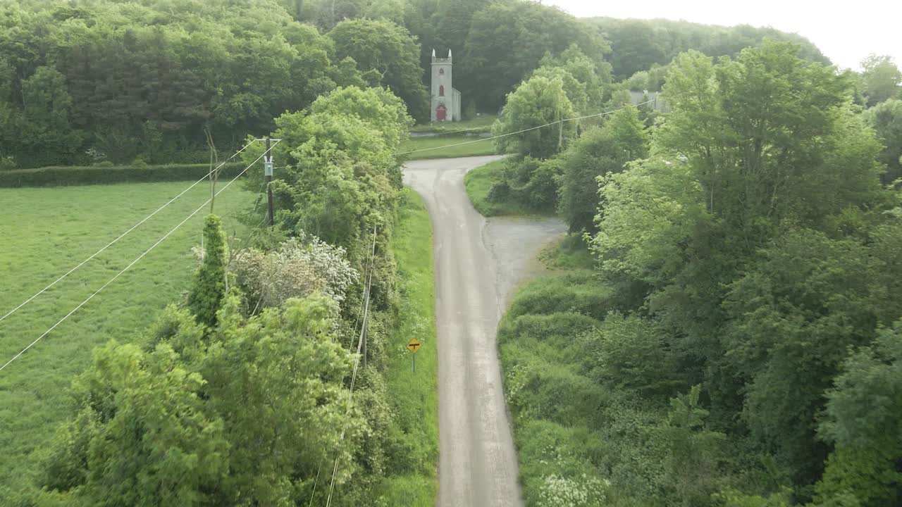 Road Along The Green Trees And Meadow Towards The Curraclone Church In Stradbally, Laois, Ireland