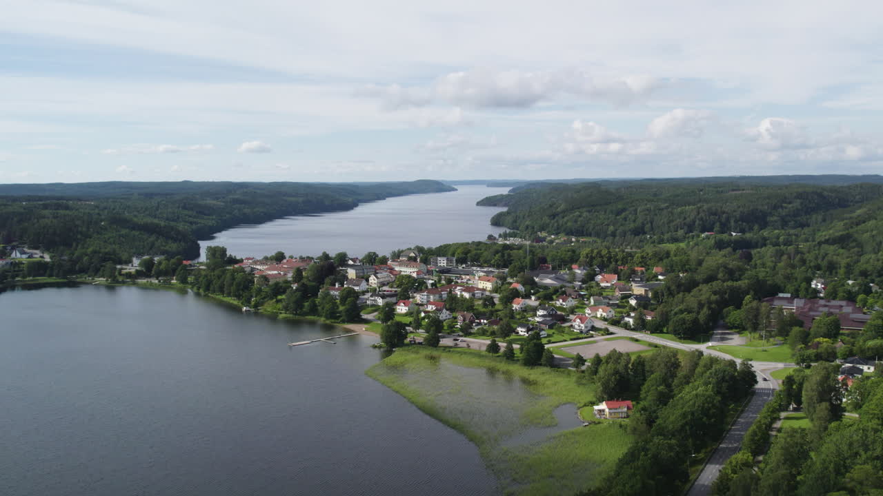A scenic lakeside village in Dals-Ed Municipality, Sweden, surrounded by lush greenery