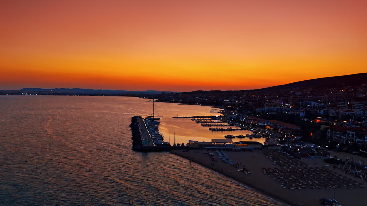 Bright sunset over the sea with golden sky and reflections on water. A colorful sunset view with golden and orange tones reflecting over the calm sea