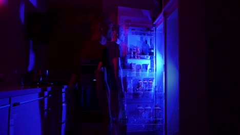 teenager snacking in the fridge at night