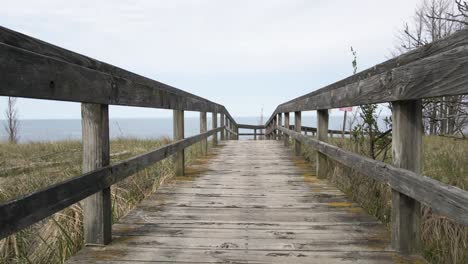 Stopping-drone-mid-flight-over-boardwalk-in-POV