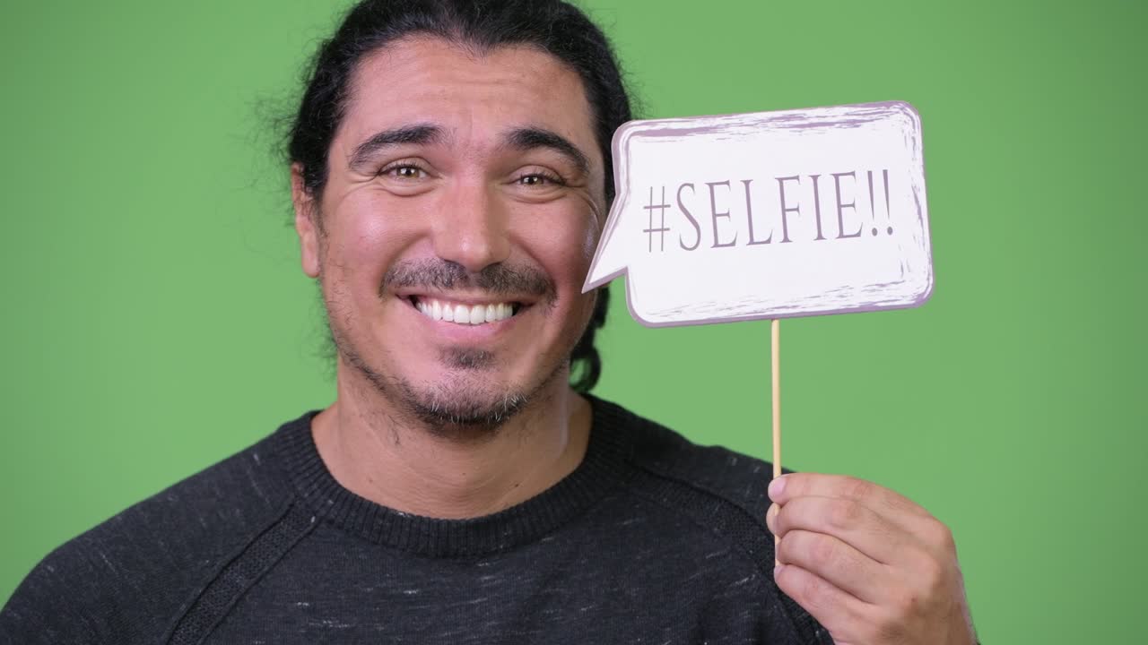 Handsome man holding selfie paper sign