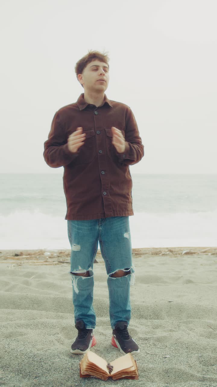 Man Praying With Passion On The Beach With The Bible Book