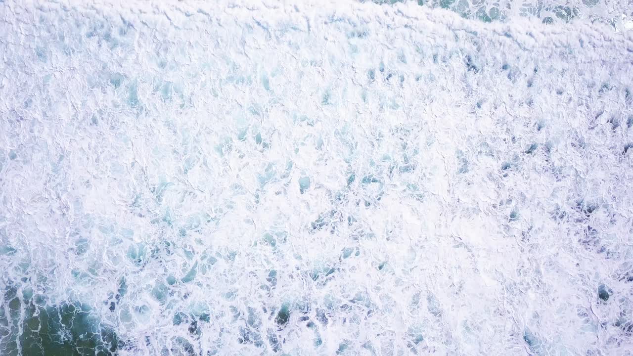 Strong blue waves in ocean crashing on the shore