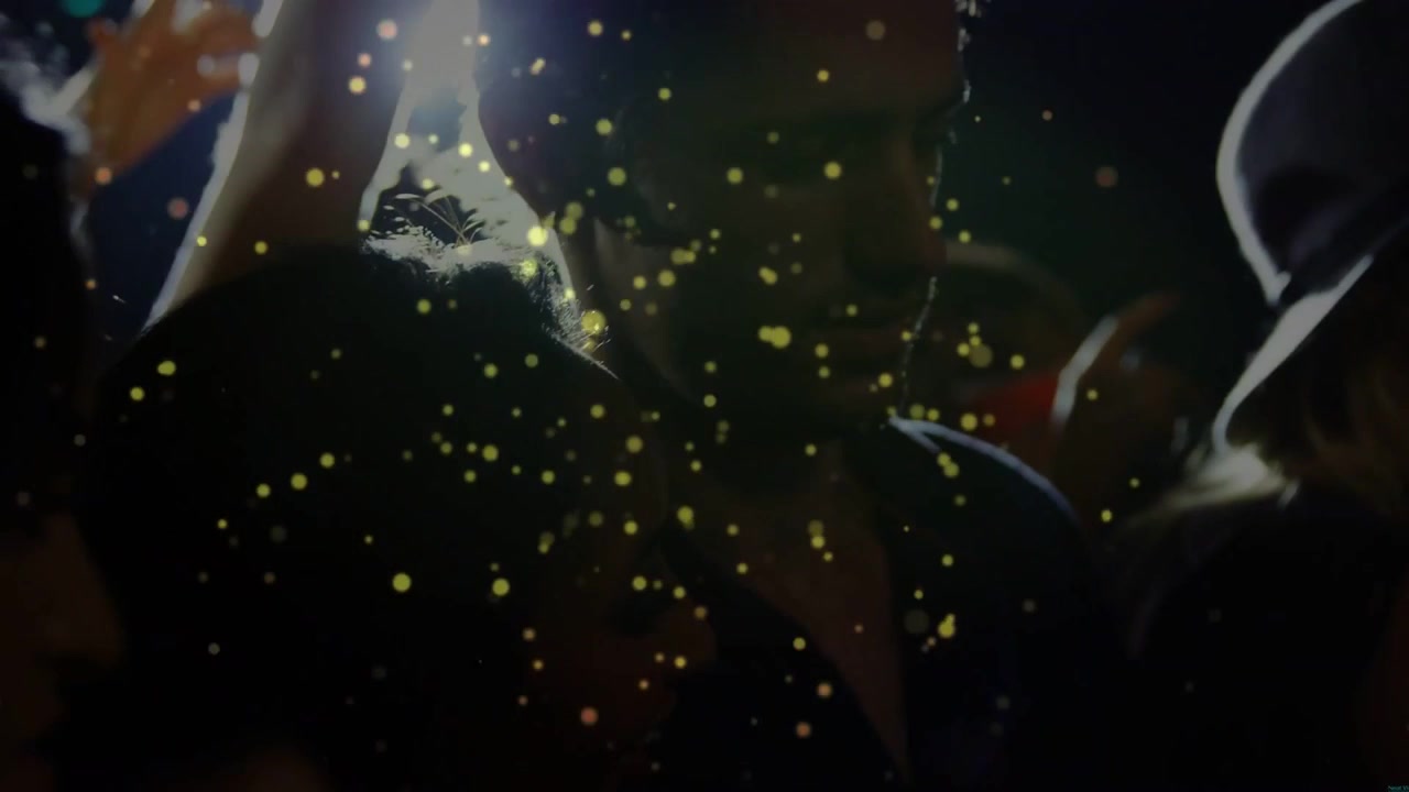 Left event light rising, woman with wide brim hat showing profile smiling as gold confetti drifting