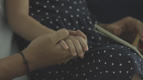 Father-Holding-Hands-Of-Daughter-In-His-Lap