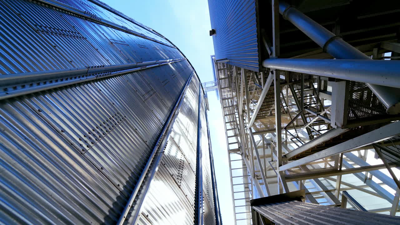 Grain elevator. Industrial granary. Modern silo for processing grain. New equipment for agribusiness. Close-up. View from below.