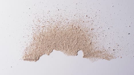 video of close up of sand grains and copy space on white background