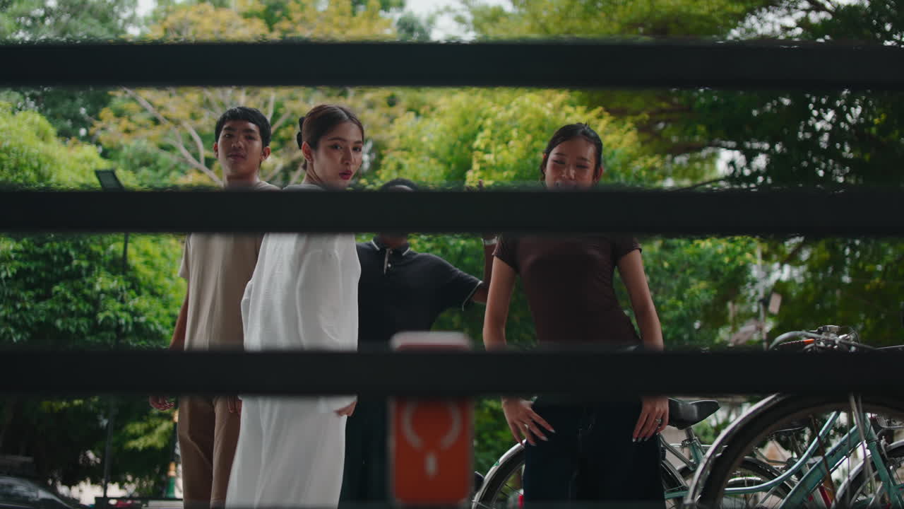 People behind a fence with a bicycle