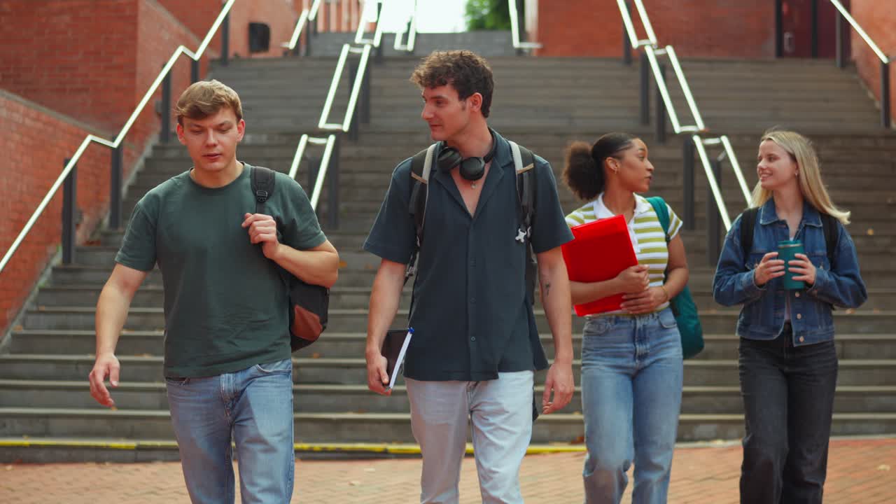 Group of college students walking down stairs on campus