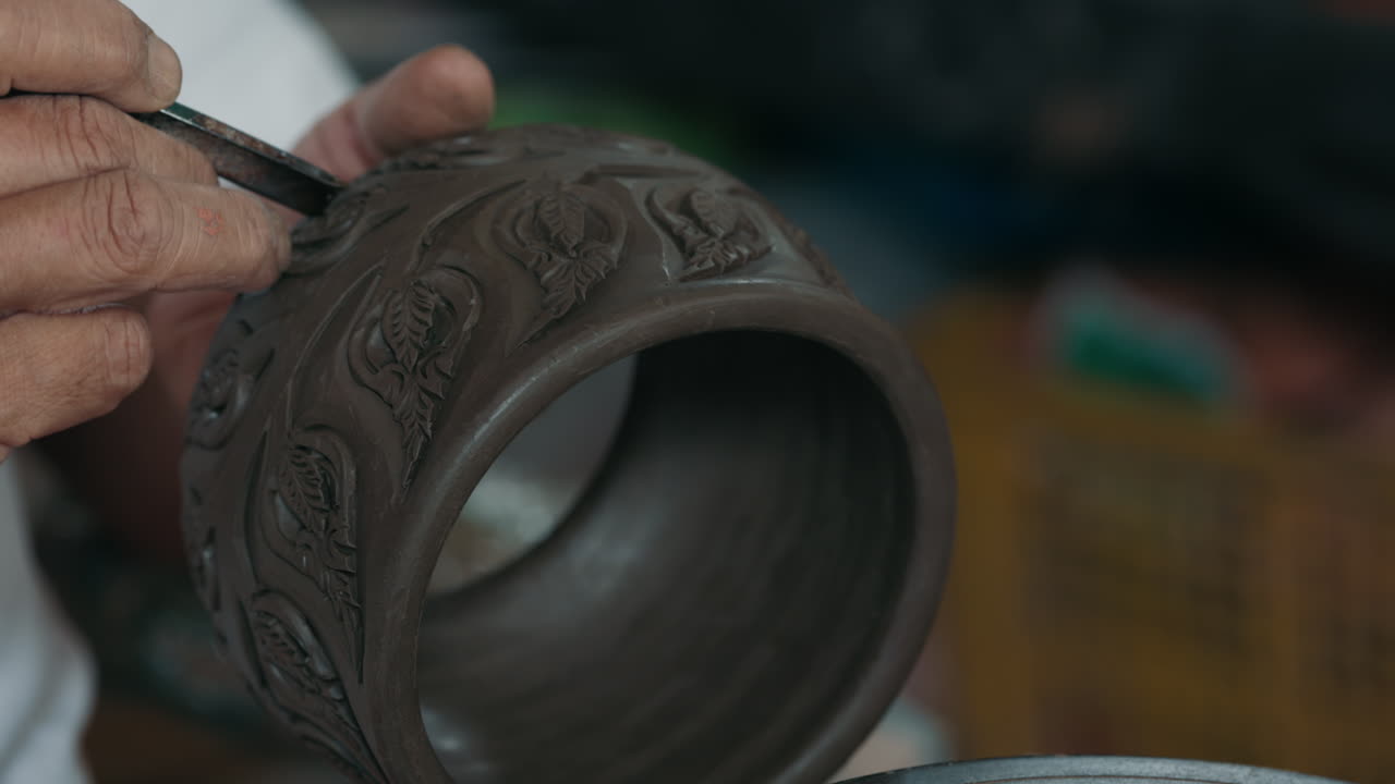 Closeup of a Potter Working on a Clay Pot