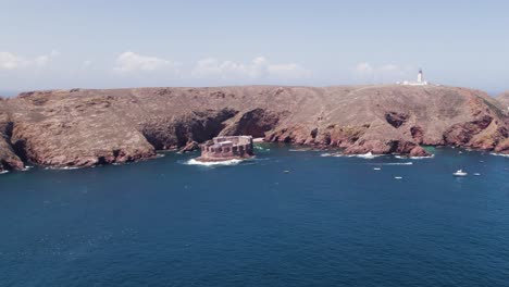 aerial: portugal's berlengas archipelago, fort and lighthouse in the backdrop